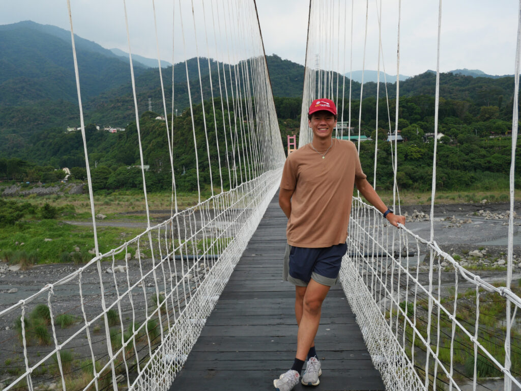 Richard standing on a suspended bridge